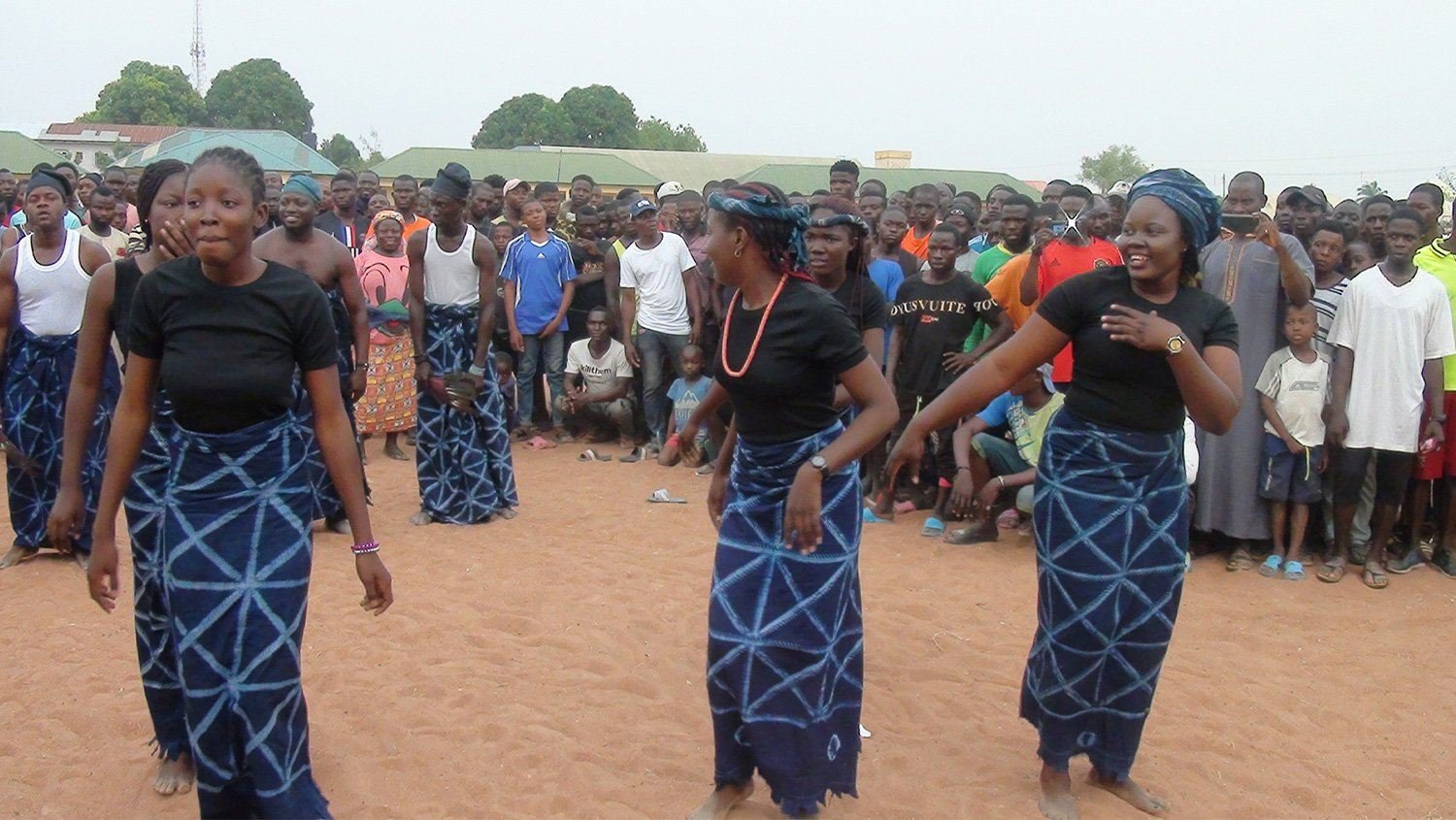 Community members dancing together at an FPHCM peace and unity festival